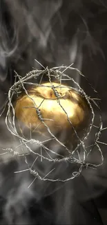 Golden apple wrapped in barbed wire on a dark background.