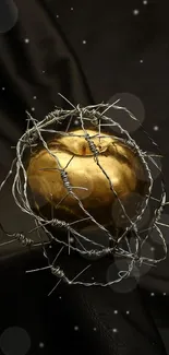 Golden apple wrapped in barbed wire on dark background.