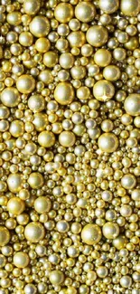 Golden beads pattern in shimmering mobile phone wallpaper.