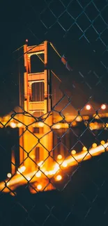 Golden Gate Bridge illuminated at night with orange hues and city lights.