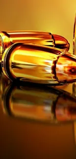 Golden bullets with a reflective surface on a phone wallpaper.