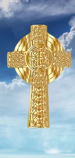 Golden Celtic cross against a blue sky.