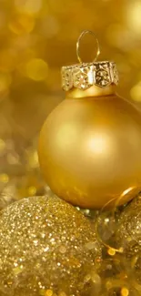 Golden Christmas bauble with glitter ornaments.