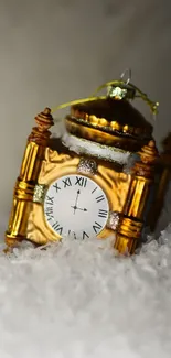 Golden clock ornament nestled in snow, elegant winter vibe.