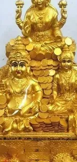 Golden deity statue with elegant design and stacked coins.