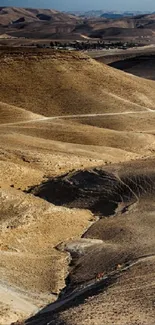 Golden desert landscape with rolling hills and distant mountains.