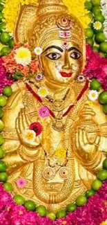 Golden deity with colorful flower garlands