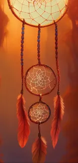 Artistic dreamcatcher wallpaper with feathers and warm orange hues.