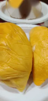 Golden durian fruit with rich texture and vibrant yellow color.