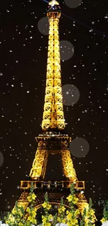 Golden Eiffel Tower with snowflakes at night.