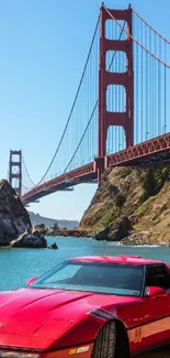 Red sports car by Golden Gate Bridge at San Francisco Bay.