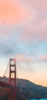 Golden Gate Bridge silhouetted against a pink sunset sky.