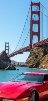 Red sports car parked near the iconic Golden Gate Bridge on a sunny day.