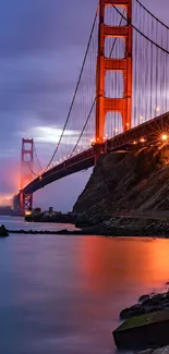 Golden Gate Bridge at dusk with stunning sky and water reflections.