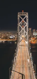 Golden Gate Bridge lit up against a cityscape at night.