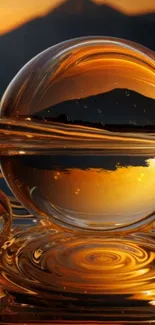 Golden glass sphere reflecting serene sunset landscape.