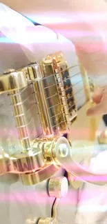 Close-up of a golden guitar with colorful light streaks.