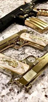 Luxury gold and black firearms displayed on marble.