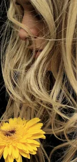 Close-up of golden hair with a bright yellow flower in focus.