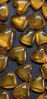 Golden heart-shaped gems on a dark background.