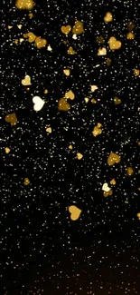 Golden hearts floating on a black background.