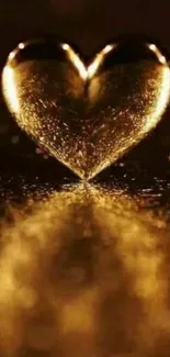 Golden heart with reflection on a dark background, creating a warm and elegant look.