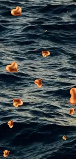 Golden hearts floating on dark ocean waves, artistic wallpaper.