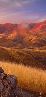 Sunset over golden hills and red mountains wallpaper.