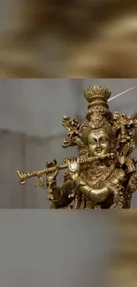 Golden statue of a Hindu deity holding a flute, beautifully detailed.