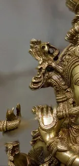 Intricate golden Hindu deity statue artwork.