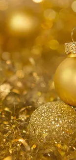 Golden holiday ornaments with sparkling decorations.