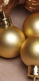 Golden Christmas ornaments on elegant background.