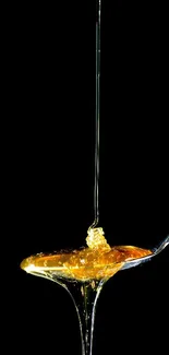 Golden honey dripping from a spoon against a black background.