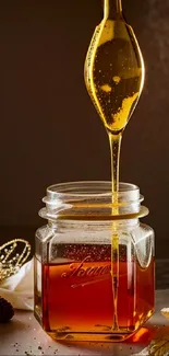 Golden honey cascading into a clear jar with warm lighting.