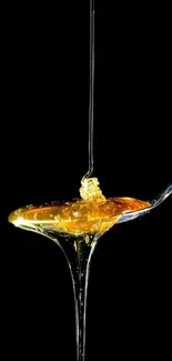 Golden honey drizzling artfully on a spoon over a black background.