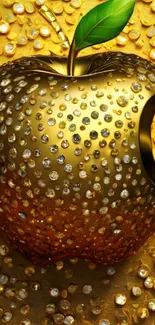 Jewel-encrusted golden apple with green leaf.
