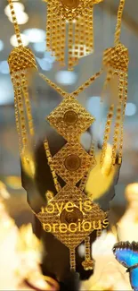 Golden jewelry with 'Love is Precious' and a butterfly.