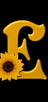 Elegant golden letter E with sunflower on black background.