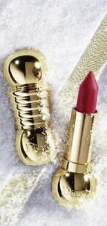 Golden lipstick on snowy surface wallpaper image.