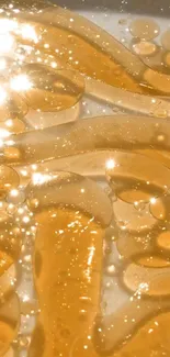 Golden liquid wallpaper with shimmering light reflections.