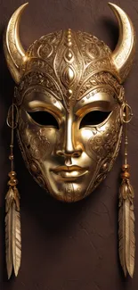 Intricate golden mask with horns on a dark background.