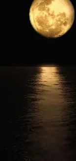 Golden moon reflecting over a calm ocean at night, creating a serene wallpaper.