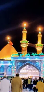 Golden-lit mosque with glowing dome and minarets at night.