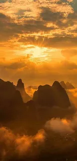 Golden sunset over misty mountains with vibrant orange sky.