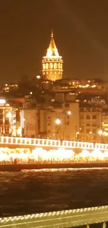 Golden-lit cityscape at night featuring Galata Tower.