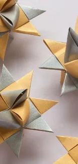 Golden and silver origami stars on a minimalist background.