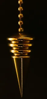 Golden pendulum on dark background mobile wallpaper.