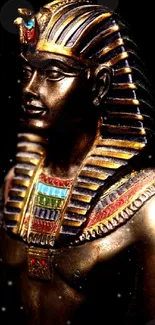 Golden pharaoh statue with intricate detail, highlighted against a dark background.