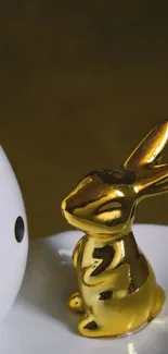 Minimalist wallpaper with golden rabbit figurine.