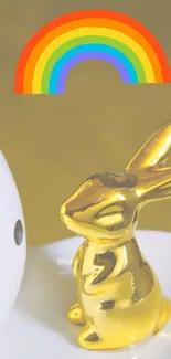 Golden rabbit figurine with rainbow charm.